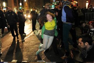 Cecily McMillan being arrested as the NYPD clears Zuccotti Park during a six-month memorial celebration of the Occupy Movement in March 2012